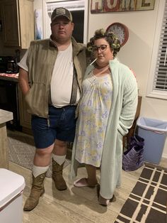 a man and woman are standing in the kitchen