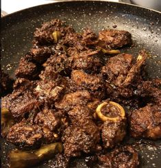 meat and peppers cooking in a frying pan