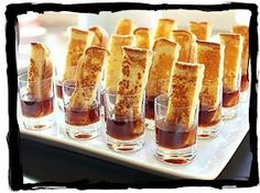 small glasses filled with different types of desserts on a white tray next to each other