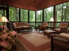 a covered porch with wicker furniture and lamps