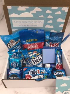 an open box filled with snacks sitting on top of a counter