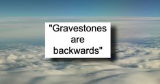 the words gravestones are backwardss above some clouds