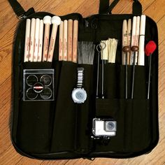 an open case with various items in it on the floor next to a wooden floor