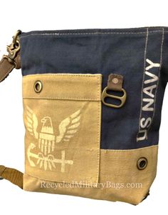 "US Navy Crossbody or Shoulder Bag is Strong, Proud and Patriotic. Our US Navy Bag is UpCycled from repurposed military tents and canvas. Perfect Size, durable and ready to report for duty!  Navy Strong: Navy Veteran, Wife and Mom or Navy YOU! Perfect gift to get or give! **Note the colors of this bag are Navy blue and tan! Some pictures may appear goldish, but color is tan** ZIP TOP CLOSURE 10.5\" x 10.5\"  ---------SIZE MATTERS! Please check out the dims! FRONT POCKET BACK ZIPPED POCKET FULLY LINED 1 ZIPPED INSIDE POCKET 2 INSIDE SLIP POCKETS ADJUSTABLE STRAP Also shown is our American Flag State Crossbody and our Navy BackPack. NOTE: Due to the nature of the materials used, there are variations in patterns, colors and imperfections may appear. These are not defects. It is the natural ap Best Beach Bag, Navy Backpack, Military Bag, Navy Military