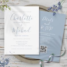 the wedding stationery is laid out on top of a plate with flowers and ribbons