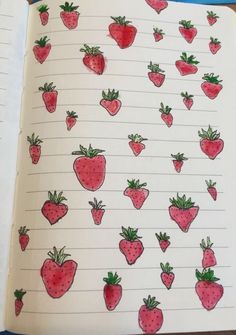 an open notebook with strawberries drawn on it