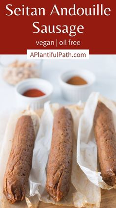 two sausages on parchment paper with dipping sauce