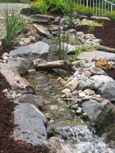 a garden with rocks and water running through it