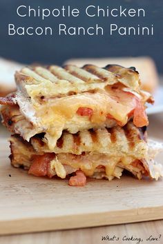 a grilled chicken bacon ranch panini on a cutting board with the words chipotle chicken bacon ranch