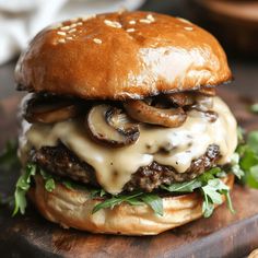 a cheeseburger with mushrooms and onions on a wooden cutting board, ready to be eaten