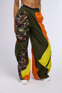 ISO: the perfect streetwear bottoms? We got you. The AKIRA Label Isa Camo And Colorblock Nylon Sweatpant is crafted from a slick, non-stretch nylon base fabrication and features a high rise design, a cinched elastic waistband, a wide leg silhouette, and a relaxed pull-on fit. Complete with a patchwork construction down both legs, consisting of colorblock and camo print sewn excess fabric and layered elastic waistband-inspired accents, resulting in a unique and ultra-baggy aesthetic. Pair these bottoms with a cropped baby tee and chunky sneakers for an on-trend finish.   - Shell 1: 100% Nylon, Shell 2: 100% Polyester - No Stretch - Imported  (all measurements are approximate from size small) - 12.25” Rise - 31.25” Inseam - Model is 5’9"  Product ID: 389937 Streetwear Bottoms, Baggy Aesthetic, Chunky Sneakers, Camo Print, Baby Tee, Infant Tees, Color Blocking, Camo, Wide Leg