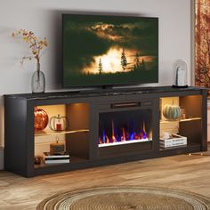 a flat screen tv sitting on top of a wooden entertainment center next to a fire place