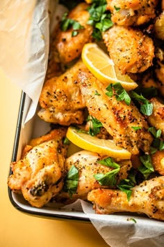 chicken wings with lemon wedges and parsley