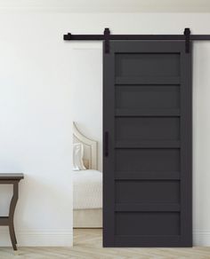 an open black sliding door in a white room