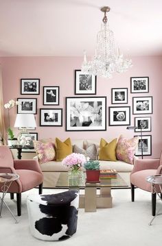 a living room filled with lots of furniture and pictures on the wall above it's coffee table