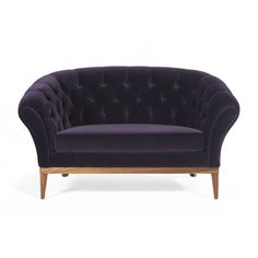 a purple velvet couch with wooden legs and buttons on the back, against a white background