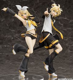 two anime figurines are posed in front of a marble background, one is wearing black and the other is white