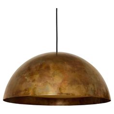 a large brass dome light hanging from a metal ceiling fixture with a black cord in front of it