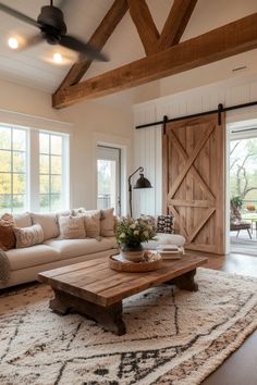 a living room with a couch, coffee table and sliding barn doors