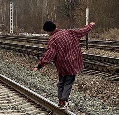 a man is skateboarding on the railroad tracks