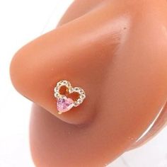 a close up of a fake breast with a heart shaped ring on it's side