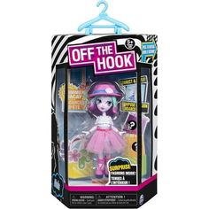 a doll in a pink dress and hat on a black and white striped box with the words, off the hook