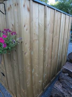 a flower pot on top of a wooden fence