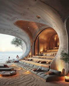 a living room filled with lots of furniture next to the ocean