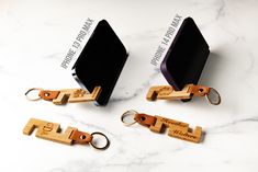 three wooden key chains attached to each other on a white marble surface with words written in black