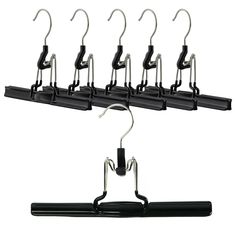 a bunch of black clothes hangers with clips on each one side and two hooks attached to the other