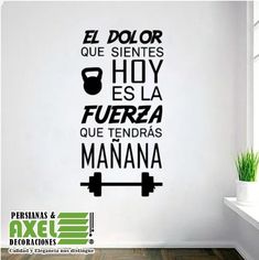 a wall sticker with the words in spanish and english on it, next to a window