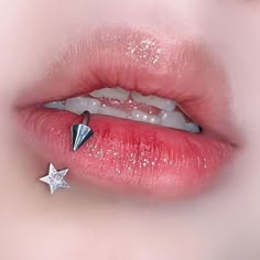 a woman's lip with a star piercing on it