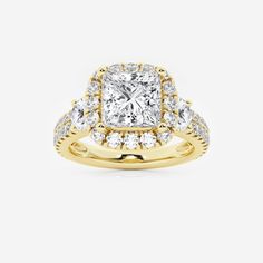 a yellow gold engagement ring with a cushion cut diamond surrounded by smaller round brilliant diamonds