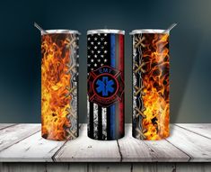 three fire and rescue canisters sitting on a table with flames in the background