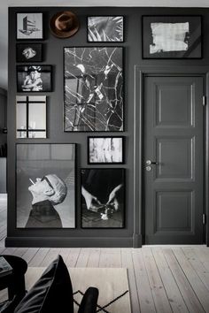 a black and white photo is hanging on the wall in this room with pictures all over it