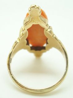 All of our jewelry is guaranteed authentic by our Graduate Gemologist of the Gemological Institute of America (GIA). Art Nouveau 10K Yellow Gold Genuine Natural Coral Cameo Ring Floral (#J2227) 10k yellow gold Art Nouveau ring with an oval coral cameo and beautiful cast mounting with flowers. The cameo measures 15mm x 8mm. The ring fits a size 4 3/4 finger and dates from 1895-1905. It weighs 2.9 dwt. Amazing! Inventory#RF2396. SKU#J2227. 100% Satisfaction Guaranteed!