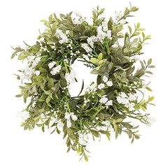 a wreath with white flowers and green leaves