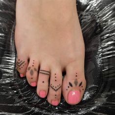 two toe tattoos are on the feet of a woman