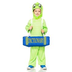 a little boy dressed as a frog holding a dictionary book in it's hands