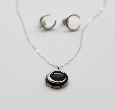 A tiny locket opens to hold two portraits.  It features a sterling silver crescent moon against a black enamel.  We've paired this piece with delicate sterling silver crescent moon stud earrings for the perfect gift. ~Comes on an 18" sterling silver chain ~Stainless steel locket measures 1/2" ~Sterling silver earrings measure 2mmx 10mm x 11mm Tiny Locket, Moon Locket, Moon Studs, Necklace And Earrings Set, Silver Gifts, Necklace And Earrings, Gift Sets, Locket Necklace, Black Enamel