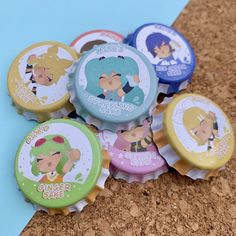 six bottle caps with cartoon characters on them