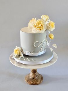 a white cake with yellow flowers on top