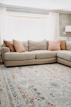 a living room filled with furniture and a large rug