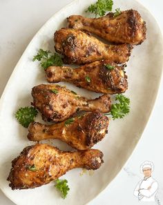 chicken wings with parsley on a white plate