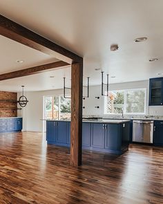 an empty kitchen with blue cabinets and wood floors is pictured in this image from the inside