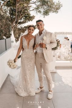 a bride and groom posing for the camera