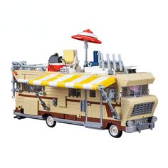 a toy bus with an umbrella attached to it's roof is shown in front of a white background