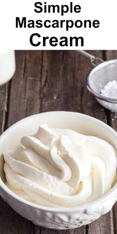 a bowl filled with whipped cream on top of a wooden table