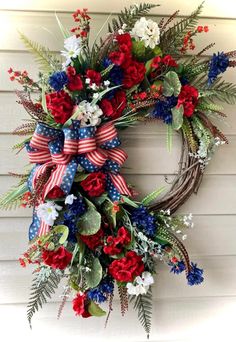 a patriotic wreath with red, white and blue flowers