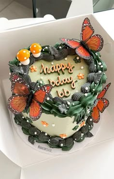 a birthday cake with butterflies on it in a box